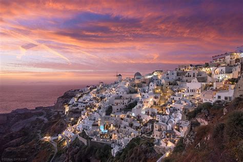 A Spectacular Sunset Over The Cliffside Houses Of Oia Santorini Oc
