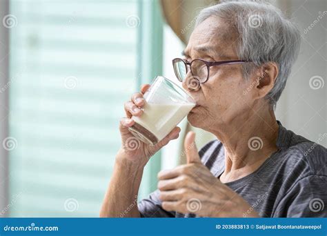 Close Upasian Senior Woman Drinking Fresh Milk From The Glasshealthy