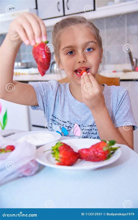 sweet girl eats strawberries stock image image of blue home 113312931