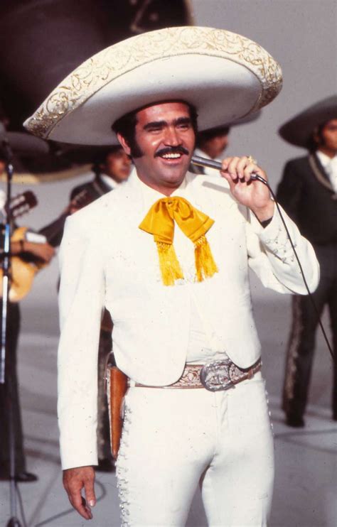 The crooner sings in spanish and works his way around the stage singing to this adoring audience who respond to his every move that he does. Vicente Fernandez over the years
