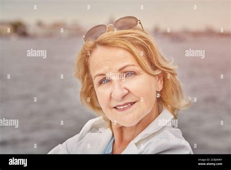 Portrait Of Attractive And Charming Aged Caucasian White Woman About 62 Years Old With Blond