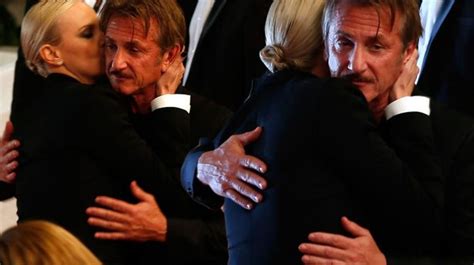sean penn looks heartbroken as ex fiance charlize theron tenderly kisses him on the cheek after