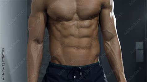Torso Of Male Fitness Model Flexing Abdominal And Pectoral Muscles