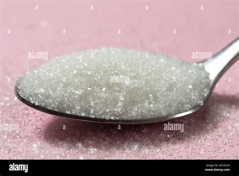 Spoon Of Sugar On Pink Background Stock Photo Alamy