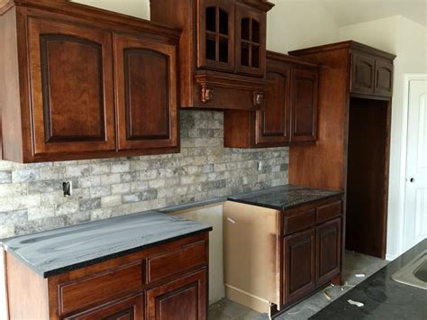 Tumbled stone subway tile backsplash installed 12/31 | Raised house