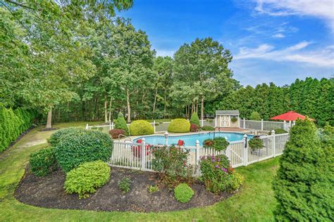 This in-ground pool is surrounded by lush landscaping adding privacy