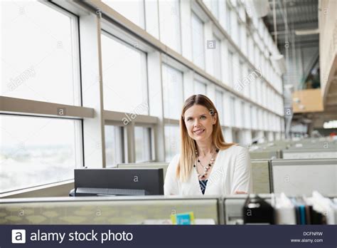 Smiling Businesswoman Standing In Office Cubicle Stock Photo Alamy