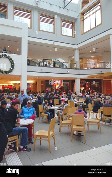 People Sitting At Tables At A Mall Food Court In Toronto Canada Stock