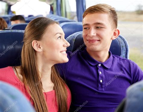 Happy Teenage Couple Or Passengers In Travel Bus — Stock Photo © Syda