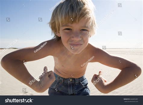 Boy Flexing Muscles On Beach Stock Photo 666845281 Shutterstock