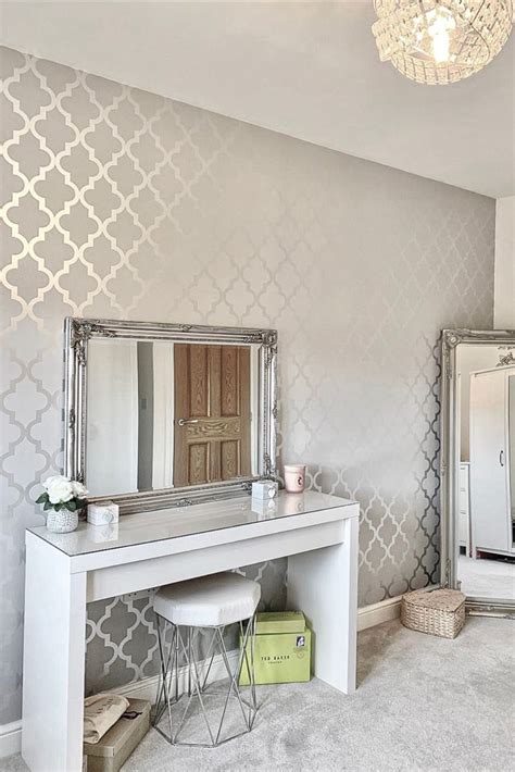 A Bedroom With A Vanity And Mirror In It