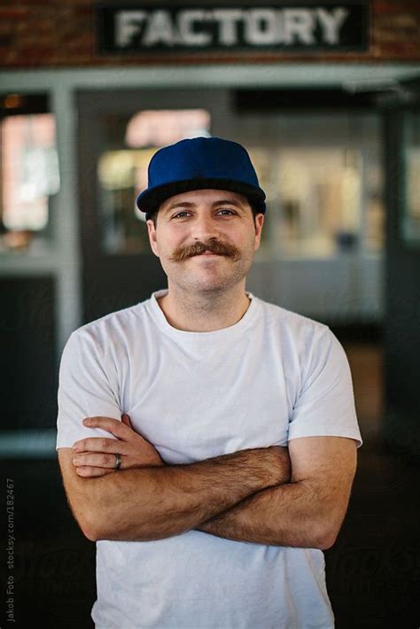 Portrait Of A Man With A Mustache And Blue Hat By Jakob Stocksy
