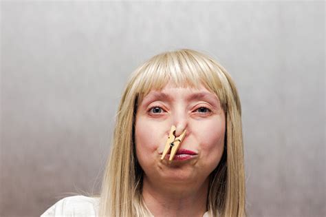 The Woman Covered Her Nose With A Clothespin Stock Photo Download