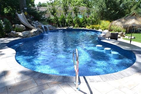 A lagoon pool might be found with lots of plants and shrubs try these 10 ideas to bring the beauty of the wild into your backyard: Steep Terrain: Creating a Backyard Escape that "Wows ...