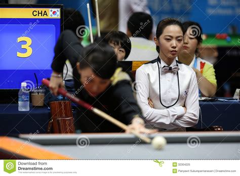 Billiard Player Rubbing A Cue Stick With A Chalk Before Playing Game