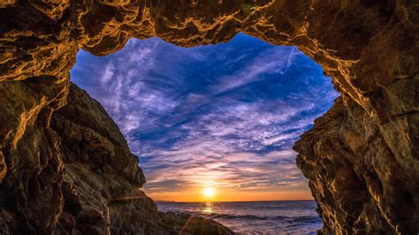 Sunset From A Sea Cave Wallpaper Backiee