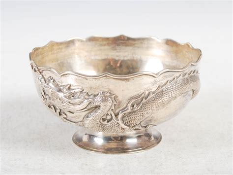 A Chinese Silver Footed Bowl Wang Hing Qing Dynasty Decorated In Relief With A Dragon Impress
