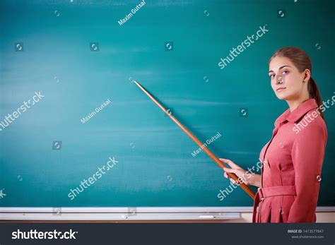 Young Woman Teacher Stands Blackboard Pointer Stock Photo 1413577847