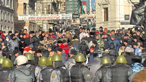 russian riot police detain 100 at economic crisis protest