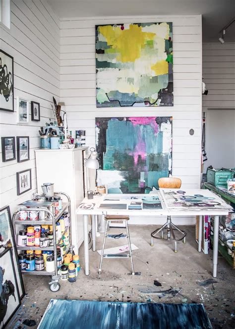 An Artists Studio With Multiple Paintings On The Wall
