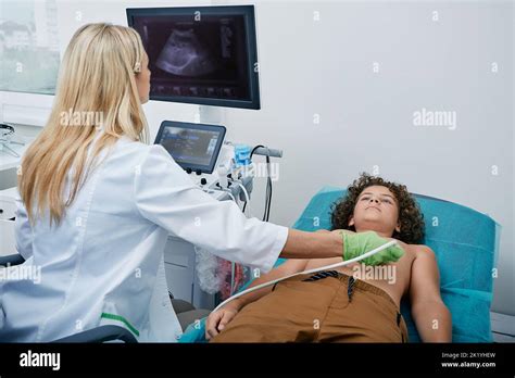 Heart Ultrasound Exam For Male Child With Ultrasound Specialist While