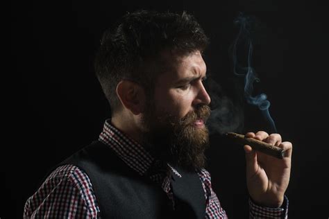 premium photo bearded man with cigar barber shop fashionable bearded men smoldering cigars