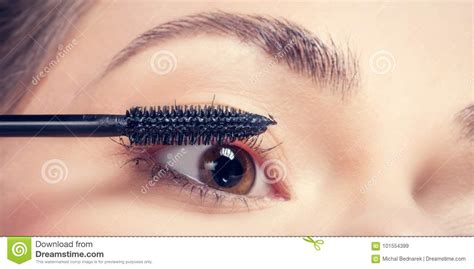 Young Woman Applying Mascara To Her Lashes Stock Image Image Of