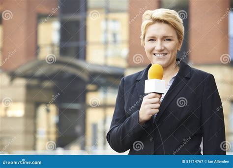 Female Journalist Broadcasting Outside Office Building Stock Image