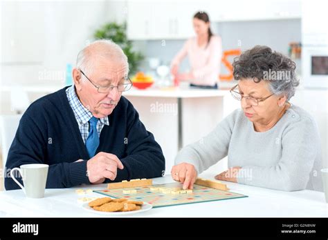 Old Couple Playing A Game Stock Photo Alamy