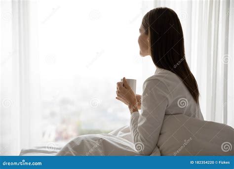 Woman Woke Up Sitting On Bed Holding Cup With Tea Stock Photo Image