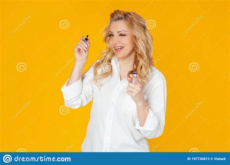 Blondine Woman In White Shirt Middle Aged European Girl Winking And Smiling Broadly While