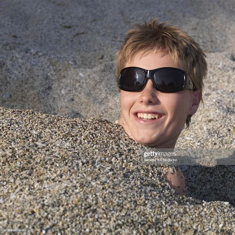 Boy Buried In Sand On Beach Smiling Closeup Portrait High Res Stock