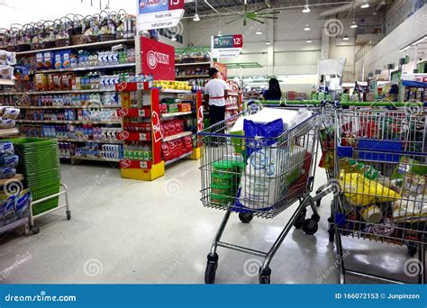 Shopping Or Grocery Carts Filled With Assorted Products Inside A
