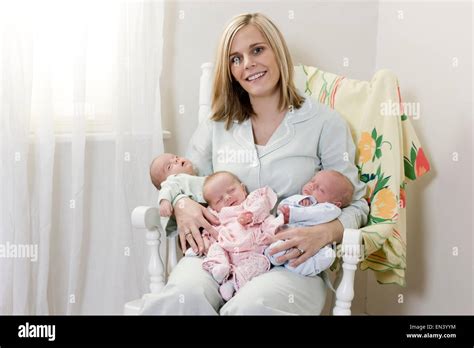 Mother With Newborn Triplets Stock Photo Alamy