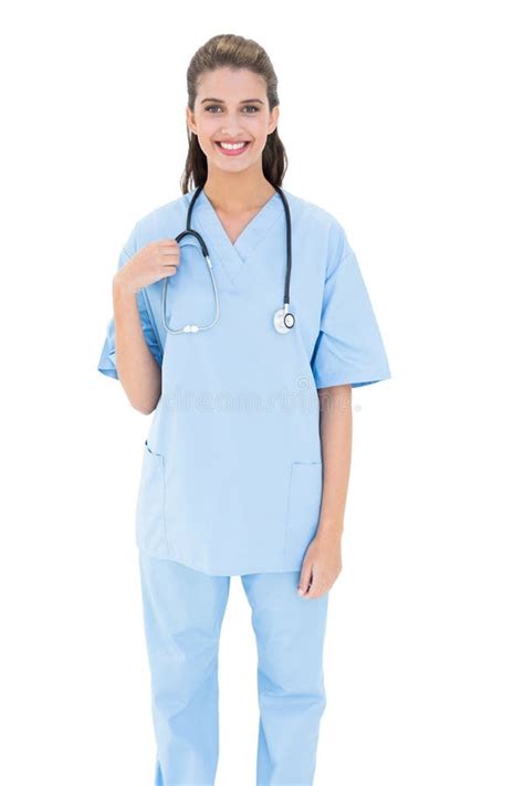 Smiling Brown Haired Nurse In Blue Scrubs Looking At Camera Royalty
