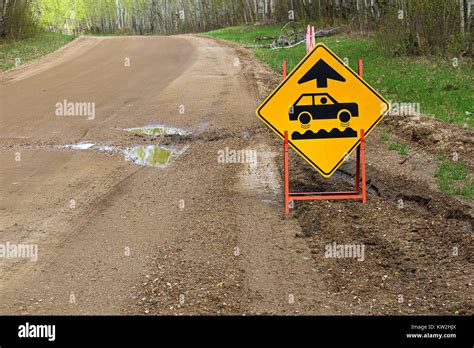 A Bumpy Road Ahead Sign With A Large Pothole Stock Photo Alamy