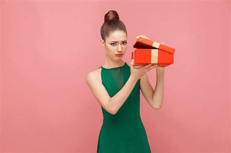You know how when you move a little and your back cracks involuntarily, you get this brief moment of everything feeling right? Woman Unboxing Red Gift Box Looking Inside Ahve Sadness ...