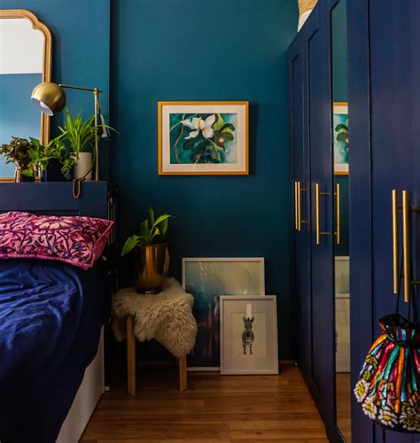 A Bedroom With Blue Walls And Wooden Flooring Is Pictured In This Image