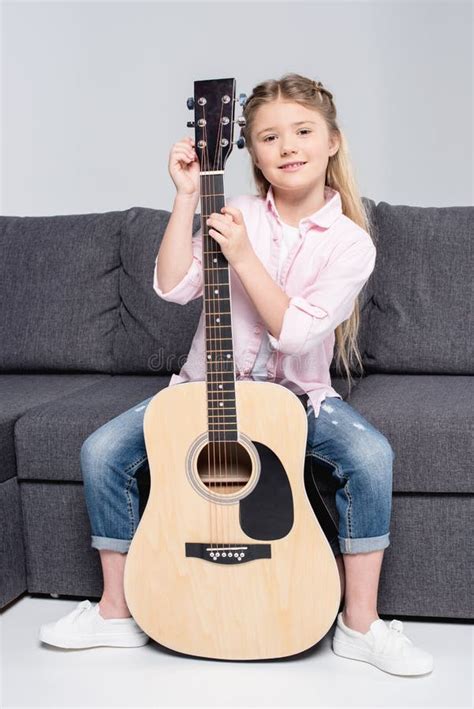Caucasian Smiling Girl In Casual Clothes Posing And Holding Guitar