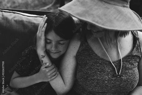 Black And White Photos Of Daughter Snuggling Up Against Her Mother
