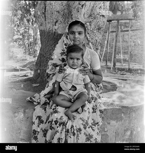 Old Vintage 1900s Black And White Picture Of Indian Mother Son Portrait Under Tree India 1940s