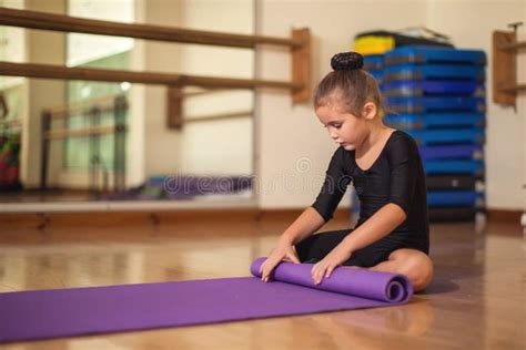 Kid At Gymnastic Class Doing Exercises Children And Sport Concept
