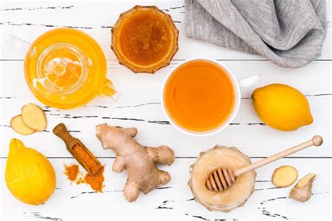 Honey Lemons And Ginger On A White Wooden Table With Two Cups Of Tea