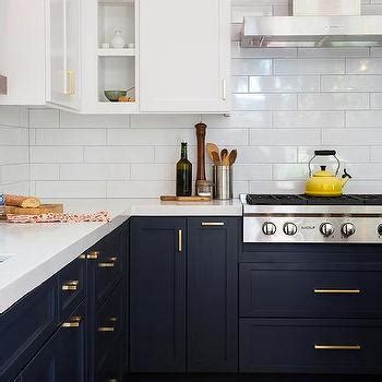 When you buy kitchen cabinets online through our free online design service, you are covered by the cabinets.com designer reassurance program, which ensures the correct cabinets and moldings are ordered to successfully complete your kitchen project. Navy Blue Kitchen Cabinets with Brushed BRass Pulls and White Marble Like Countertops ...
