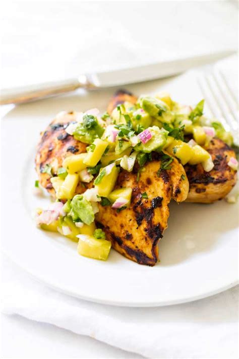 Chicken marinated in an orange and lime mixture, then grilled to perfection and topped with a tasty homemade mango salsa. Mango Avocado Salsa with Grilled Chipotle Chicken | Girl ...