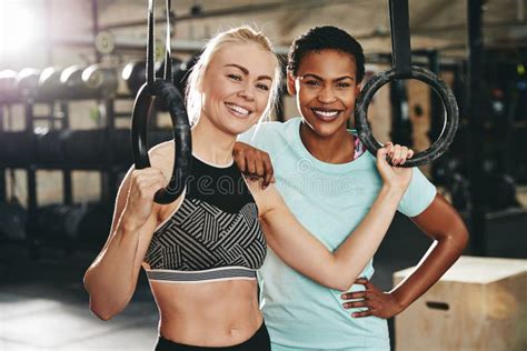 Two Smiling Friends Working Out With Rings At The Gym Stock Image