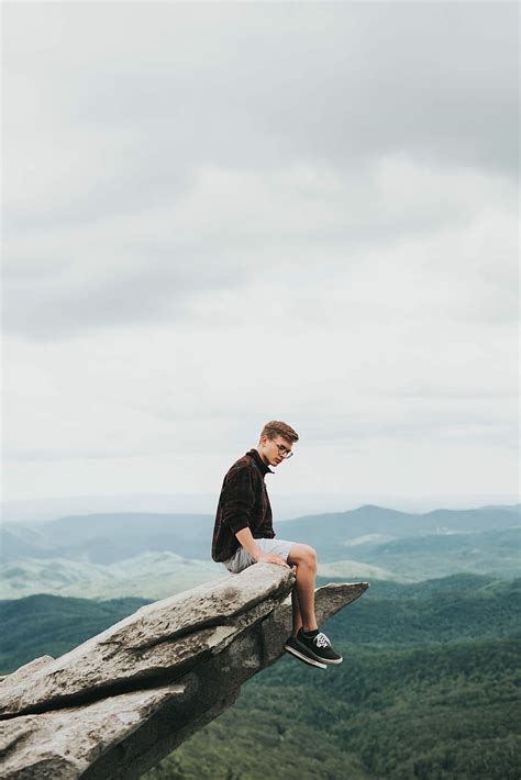 Hd Wallpaper Man Sitting On The Edge Of Stone Man Sitting On Mountain