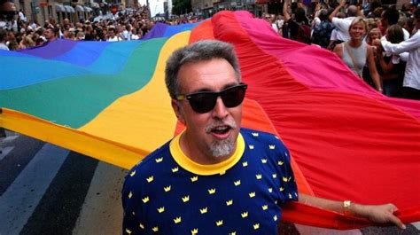 gilbert baker with the iconic rainbow coloured flag on a march in 2003 rainbow flag lgbt