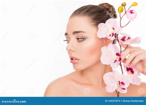Beautiful Young Woman Holding Branch Of Orchid Near Her Face Stock