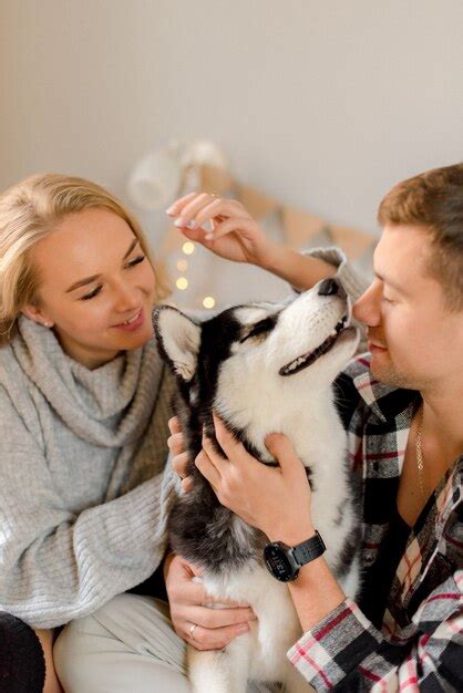 Premium Photo Couple Playing With Dog In Bedroom